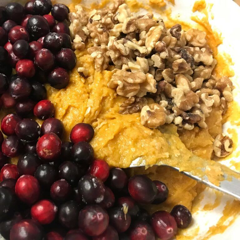 cranberries, walnuts and mixed batter in a bowl