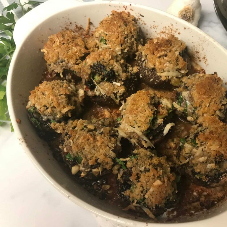 Baked Sausage, Fig and Pine Nut Stuffed Mushrooms in a casserole dish