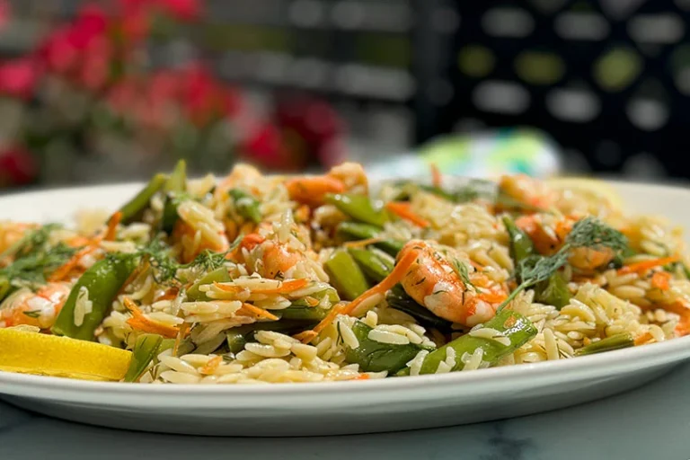 a platter of shrimp lemon dill and orzo salad.