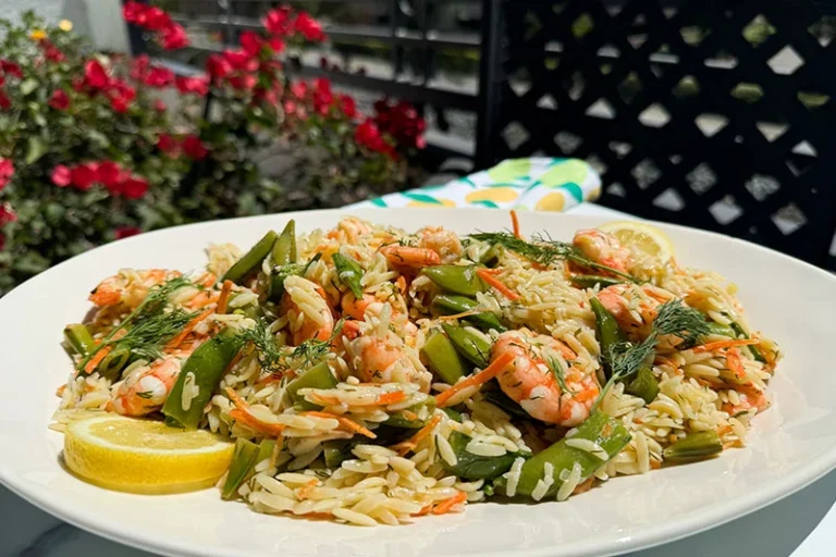 a platter of shrimp lemon dill and orzo salad.