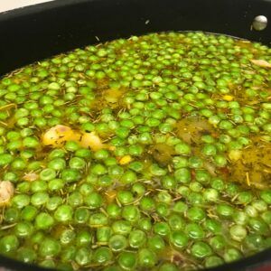 corn peas and carrots added to pot.