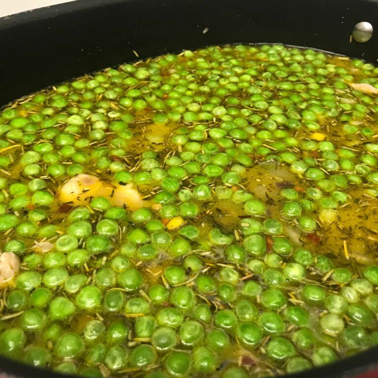 corn peas and carrots added to pot