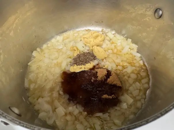 onions and ingredients for sauce in a pot.