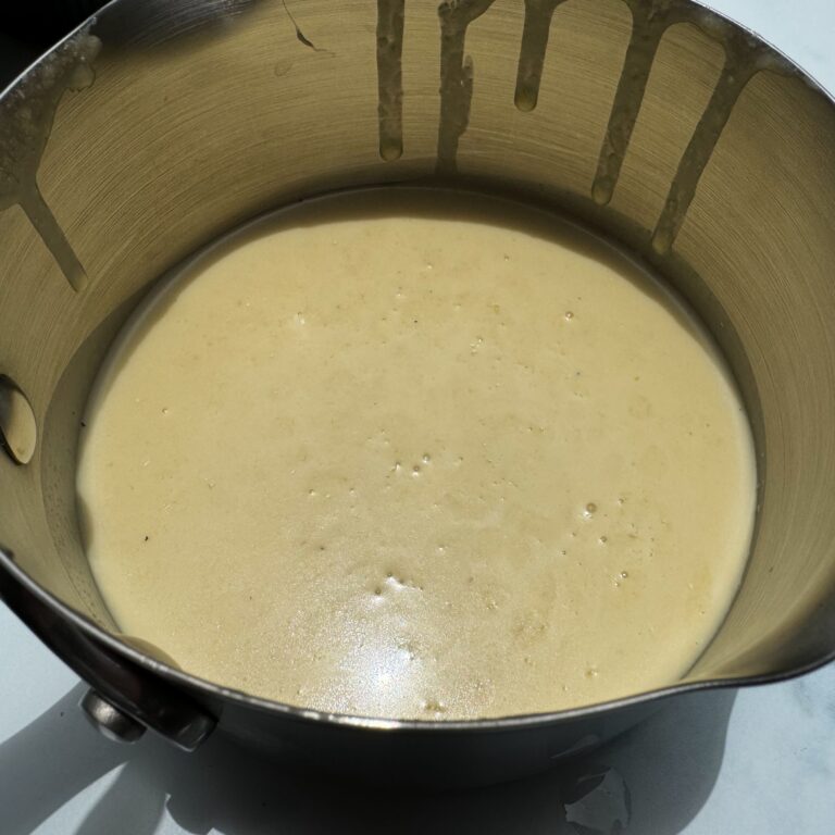 strained lemon sauce in pot.
