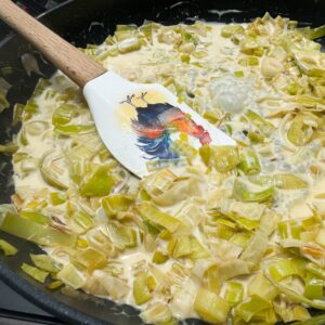 leeks, lemon juice and cream cooking in skillet.