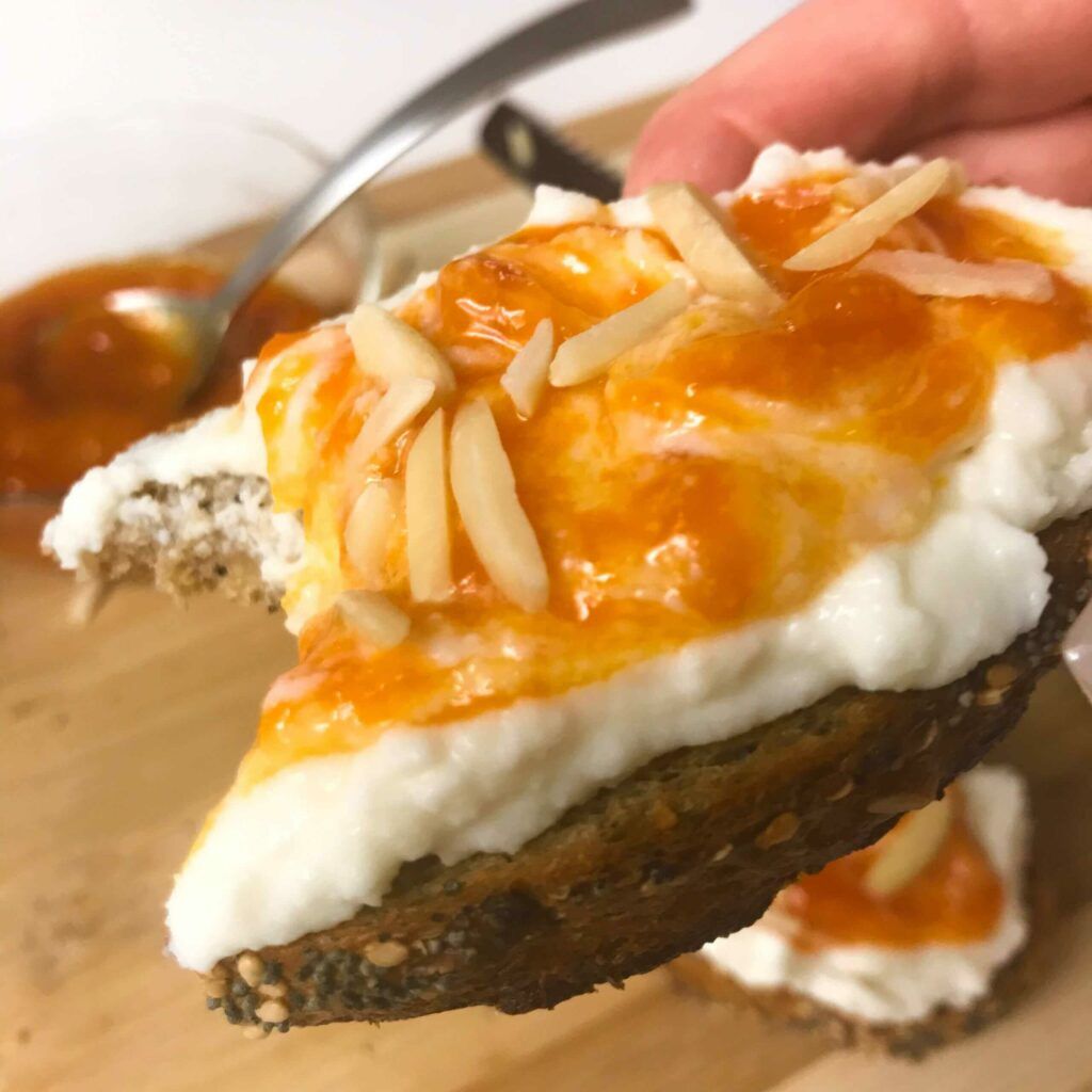 slice of the apricot jam toast with a bite taken.