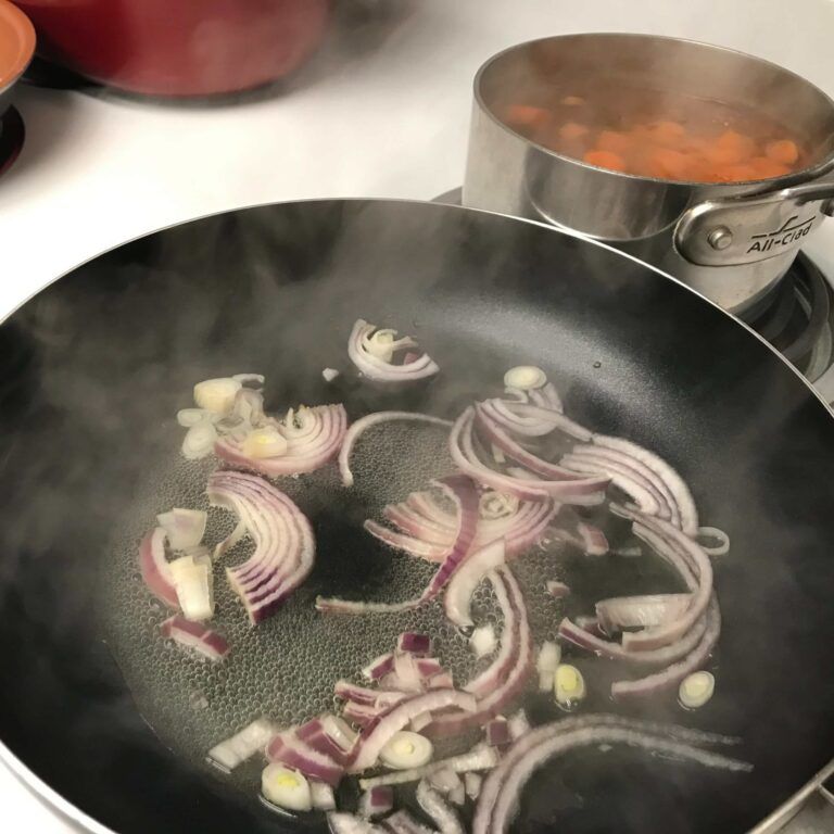 onions in water cooking on stove.