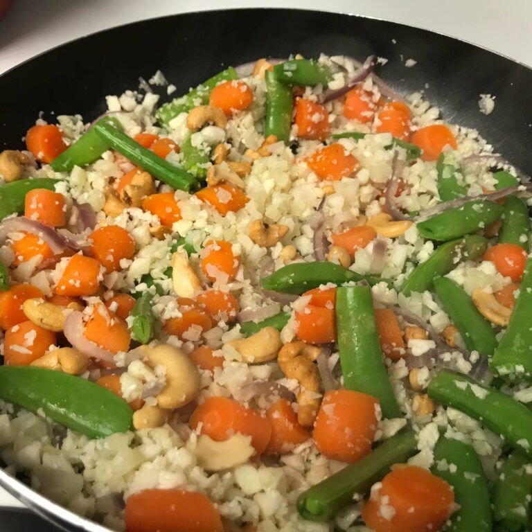 mixed veggies and nuts in skillet.