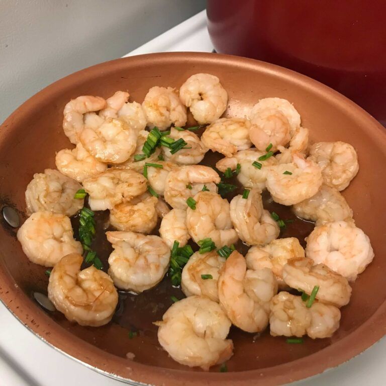 shrimp and chives in a skillet.