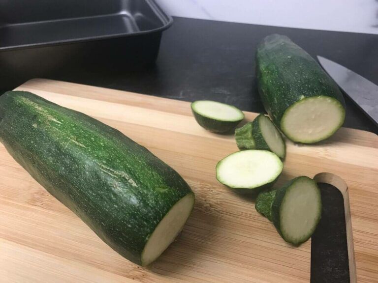 zucchini on a cutting board with a knife