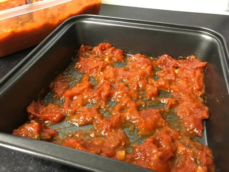 marinara sauce in the bottom of a pan