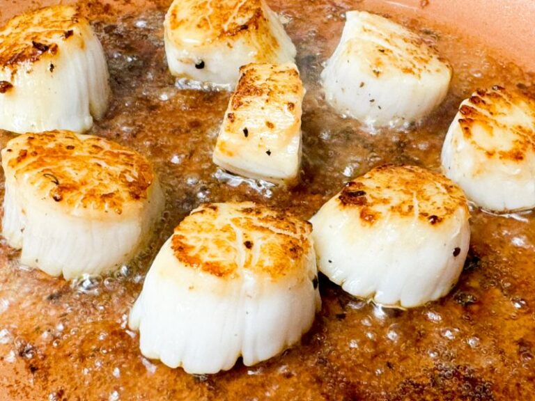 scallops searing in a skillet.