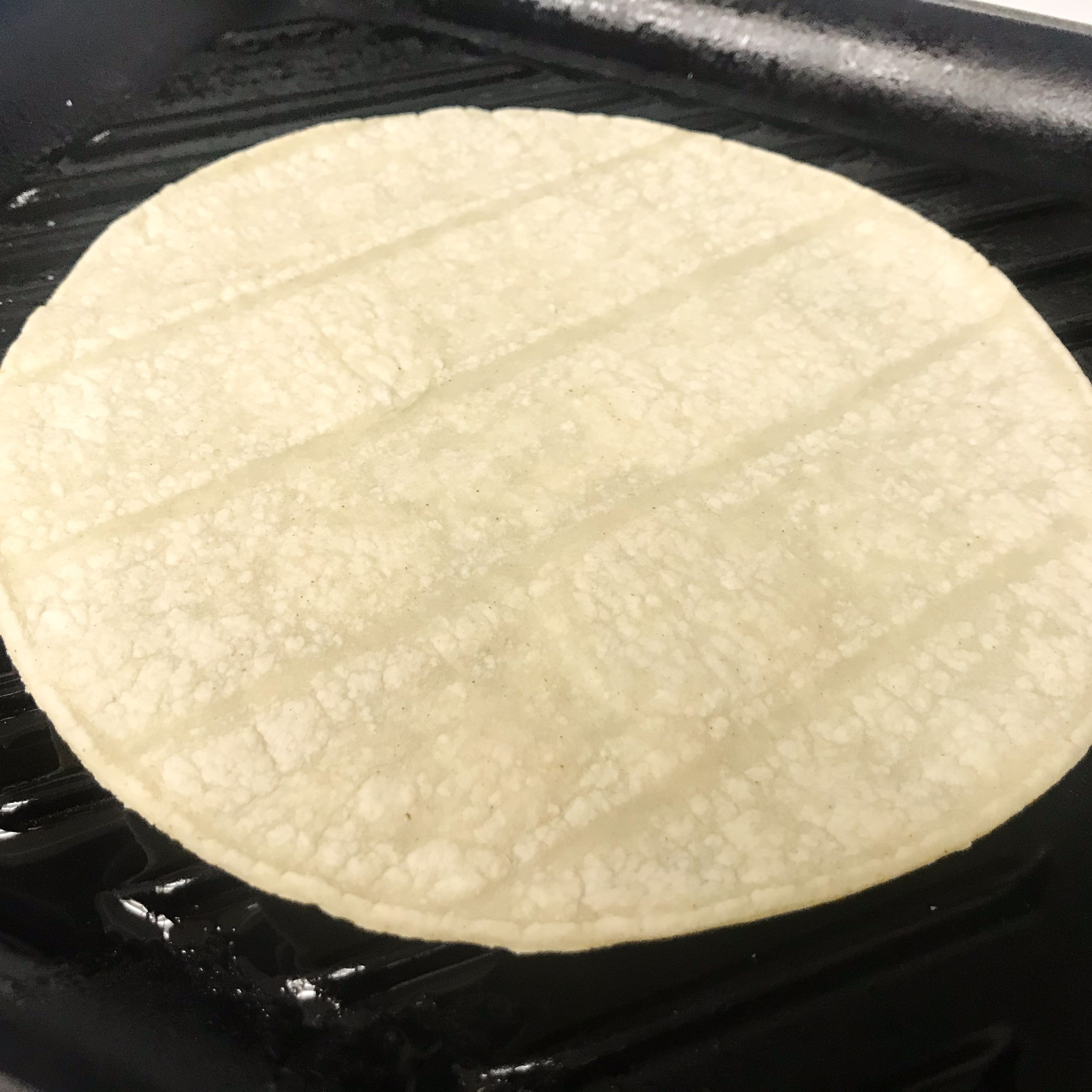 tortilla grilling on a grill pan