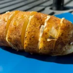 grilled baked potato on platter.