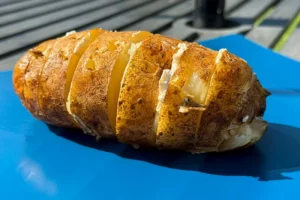 grilled baked potato on platter.