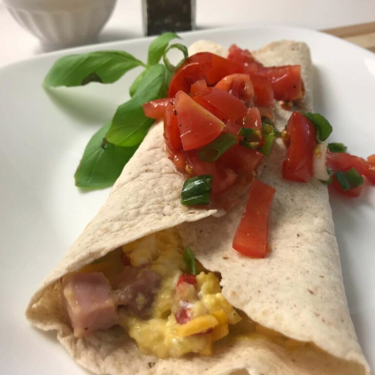 wrap topped with tomatoes, onions and basil