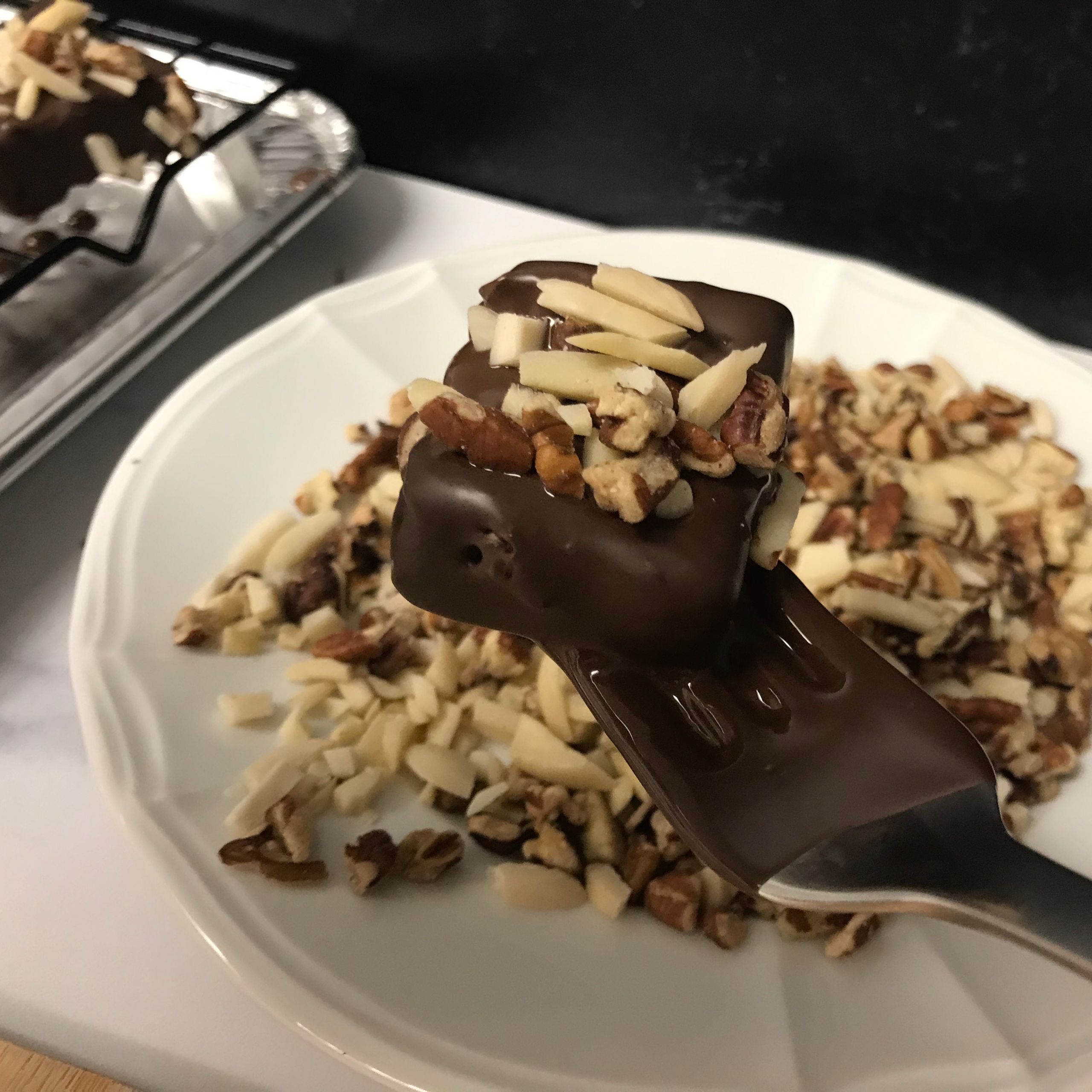 dipped ice cream square with nuts on top