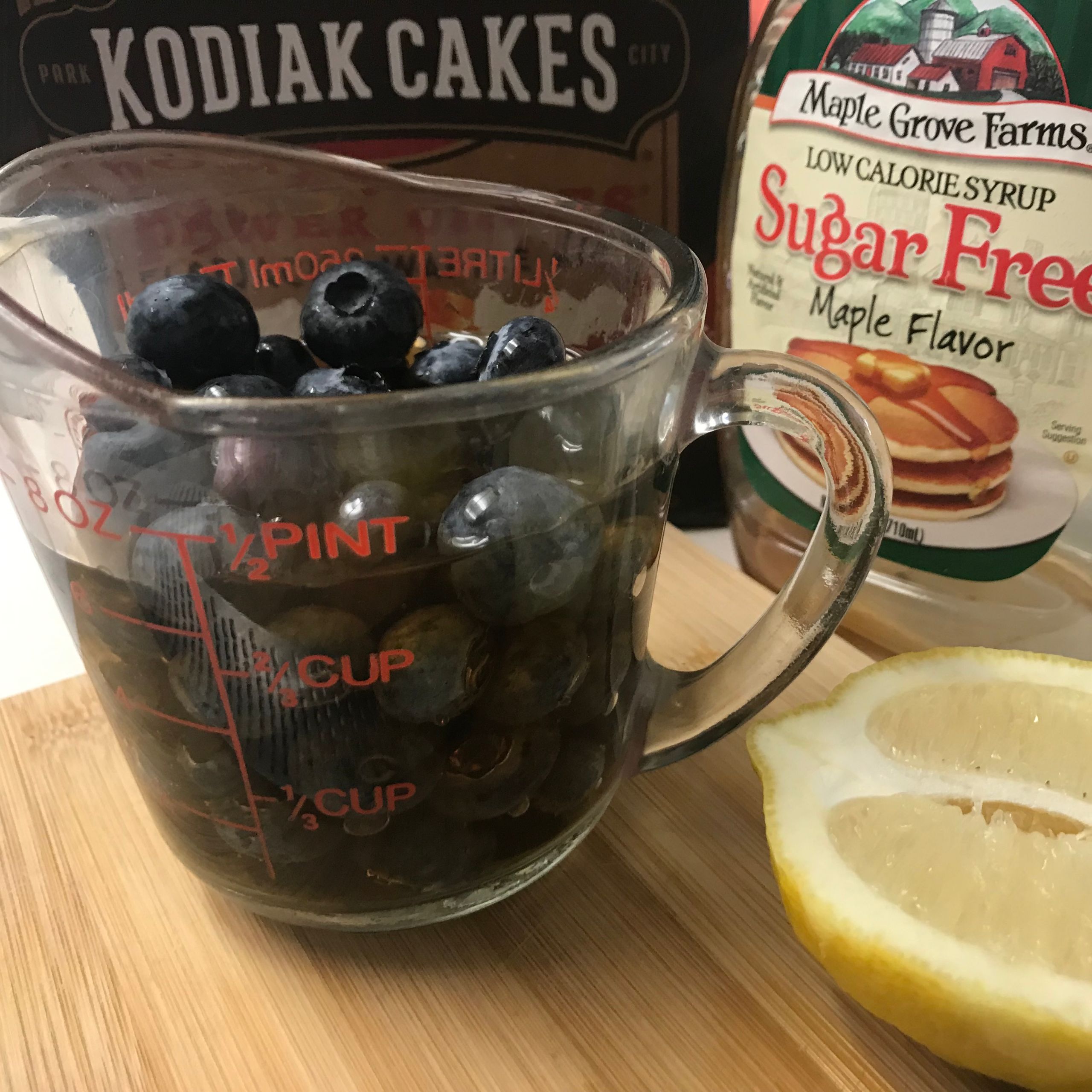 fresh blueberries and syrup in a measuring cup
