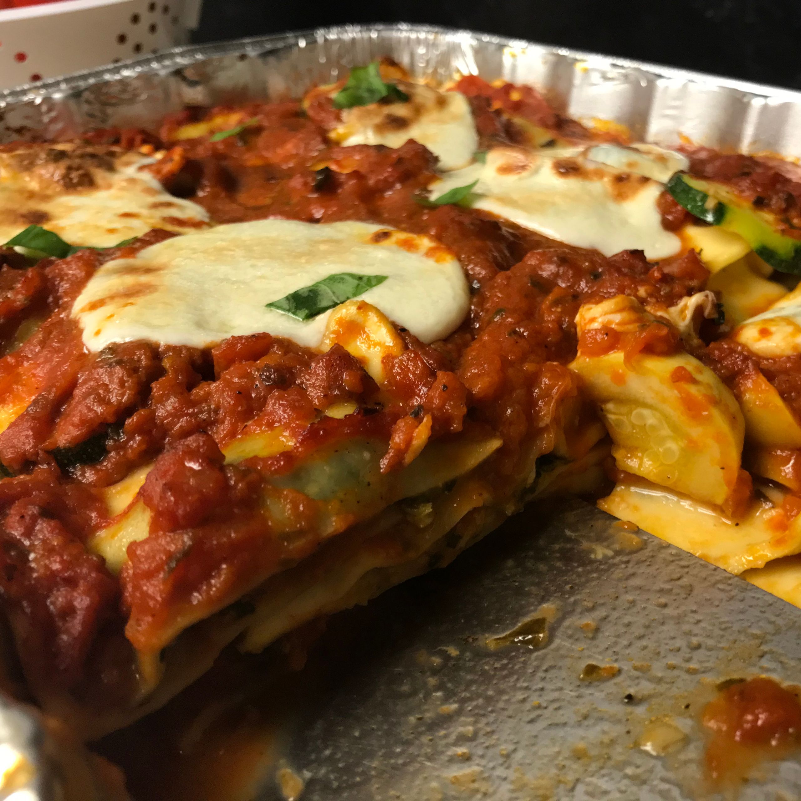 A portion cut from the tray of lasagna