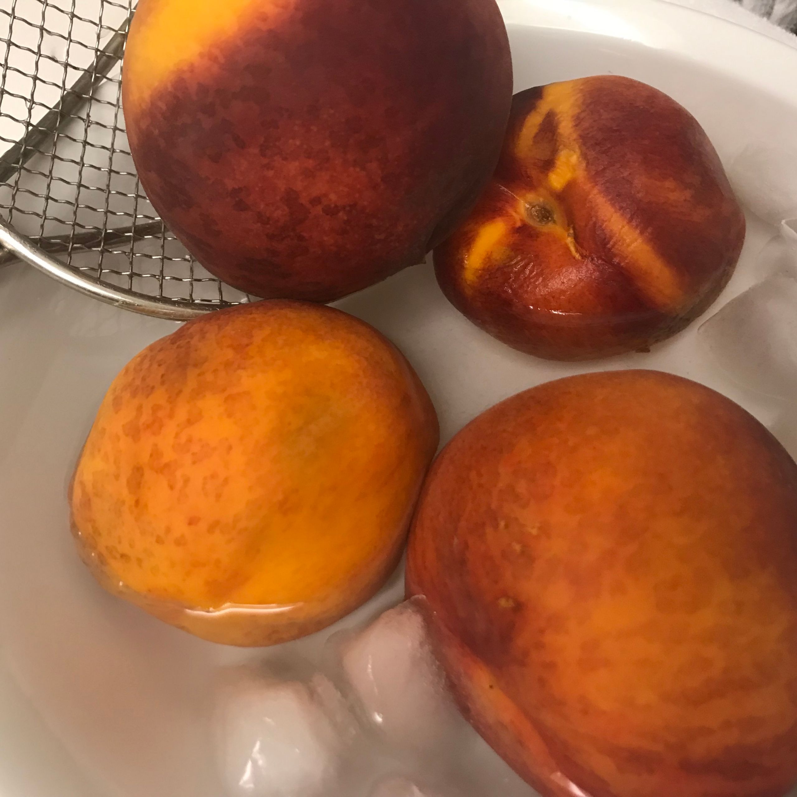 peaches being plunged in ice water