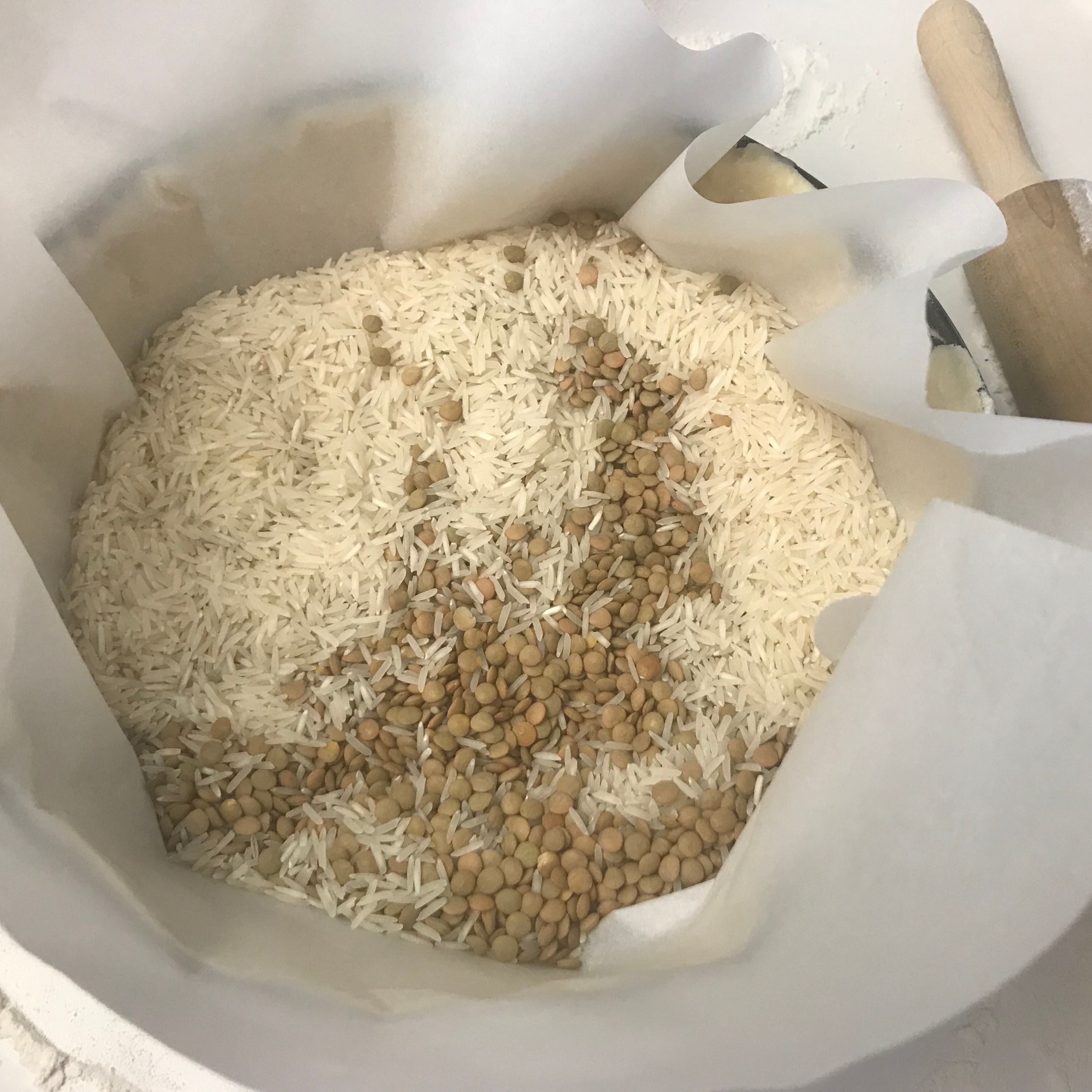 Rice and beans weighing down parchment paper