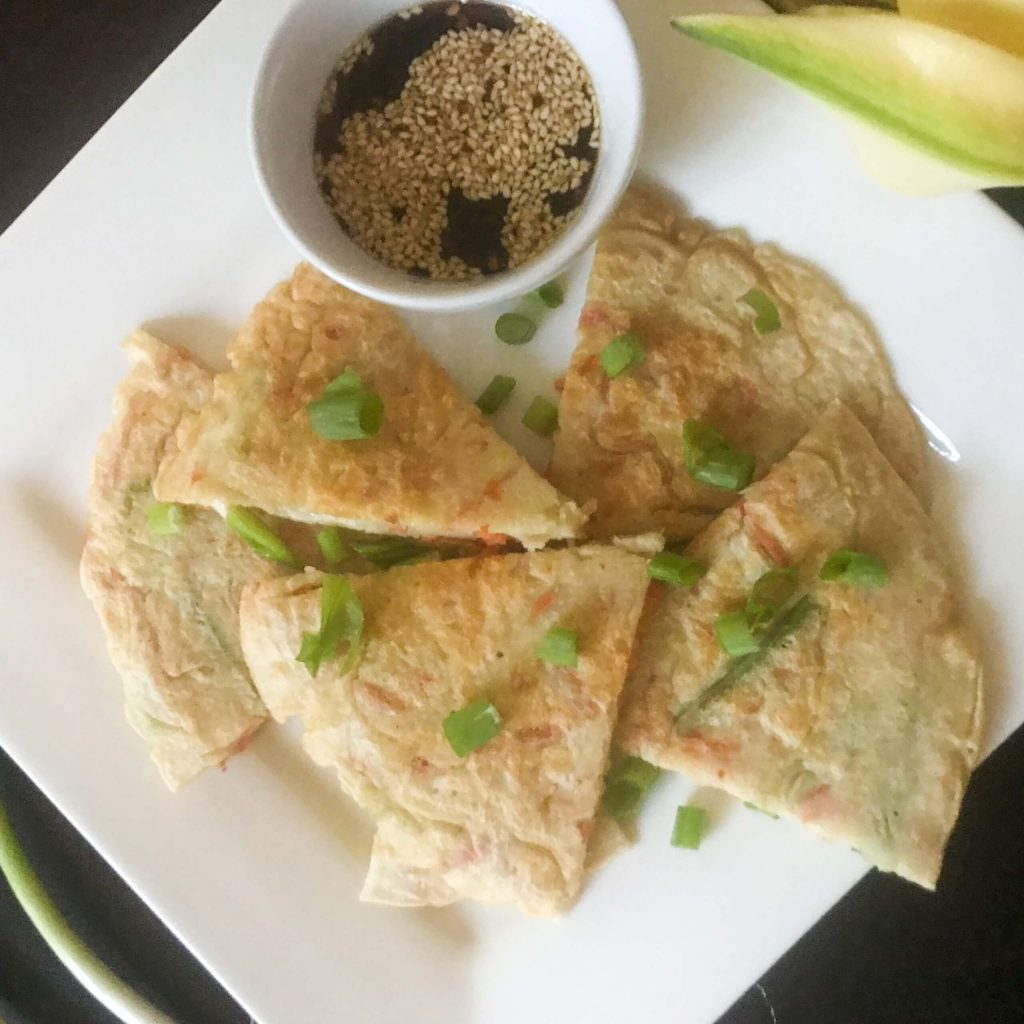 Cut pancakes on plate with dipping sauce