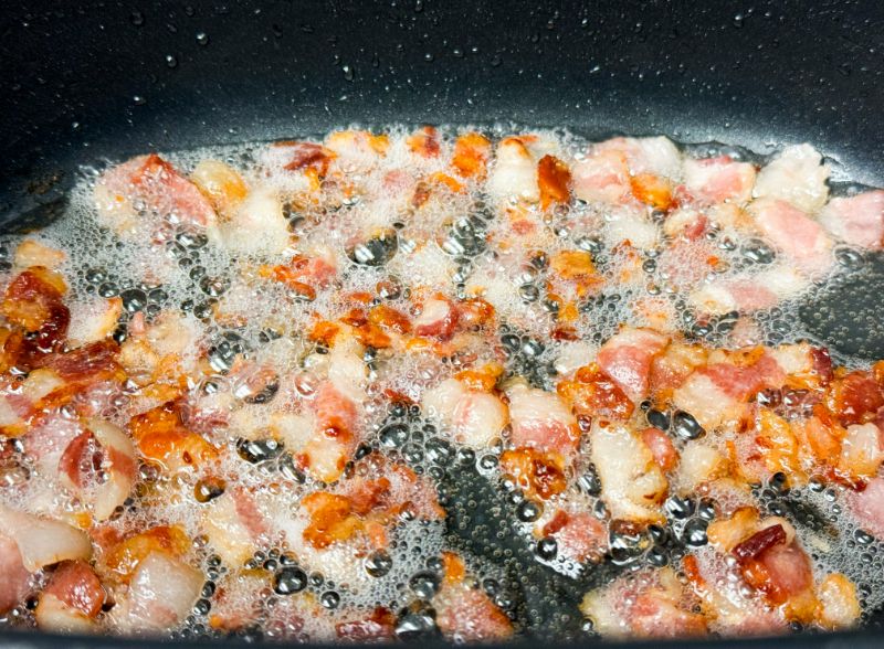 bacon cooking in a pot.