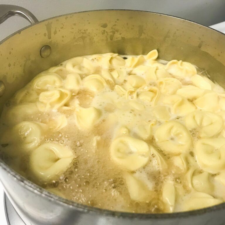 cheese tortellini cooking in broth