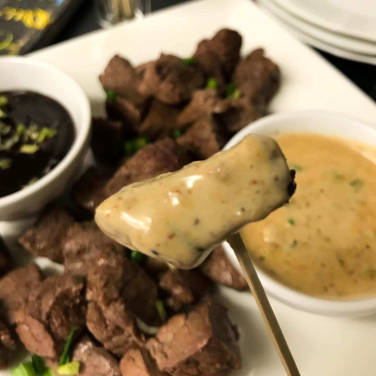 filet bite dipped in blue cheese sauce.