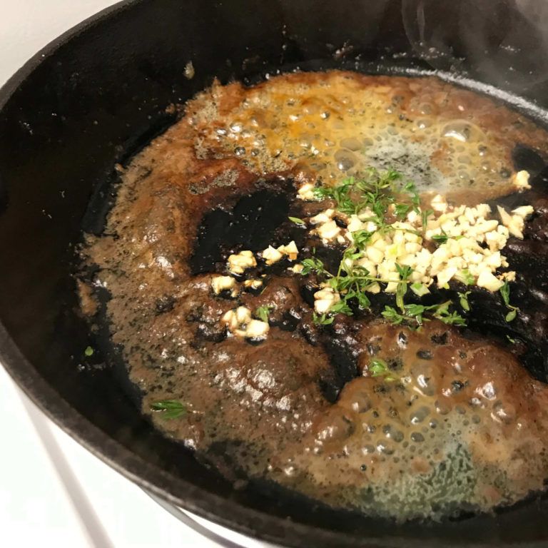 garlic and herbs added to skillet.