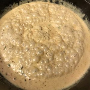 bubbling blue cheese sauce in skillet.