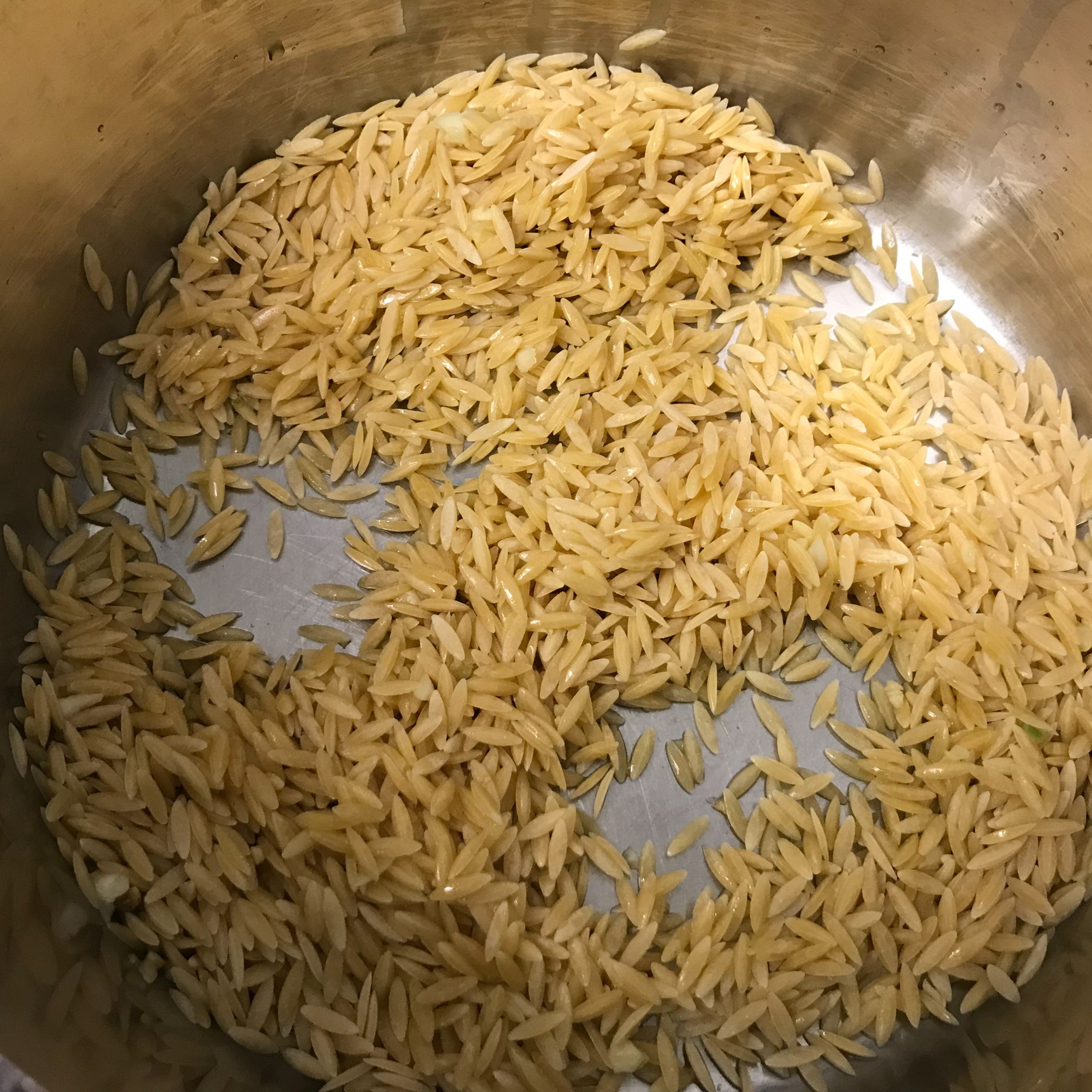 orzo toasting in garlic oil | my curated tastes