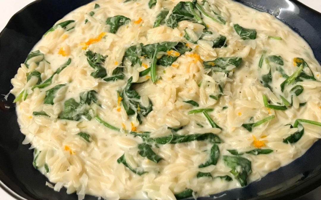 Finished whole wheat orzo orange & spinach in a bowl | mycuratedtastes