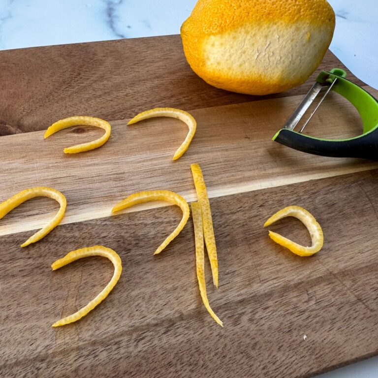 peeled lemon and strips for garnish.