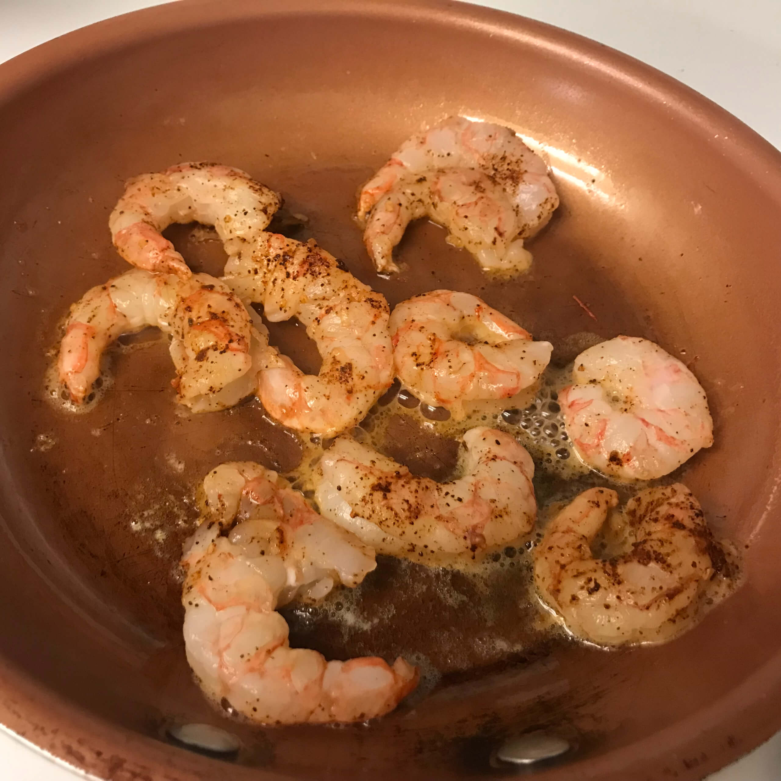 shrimp cooking in a skillet | my curated tastes