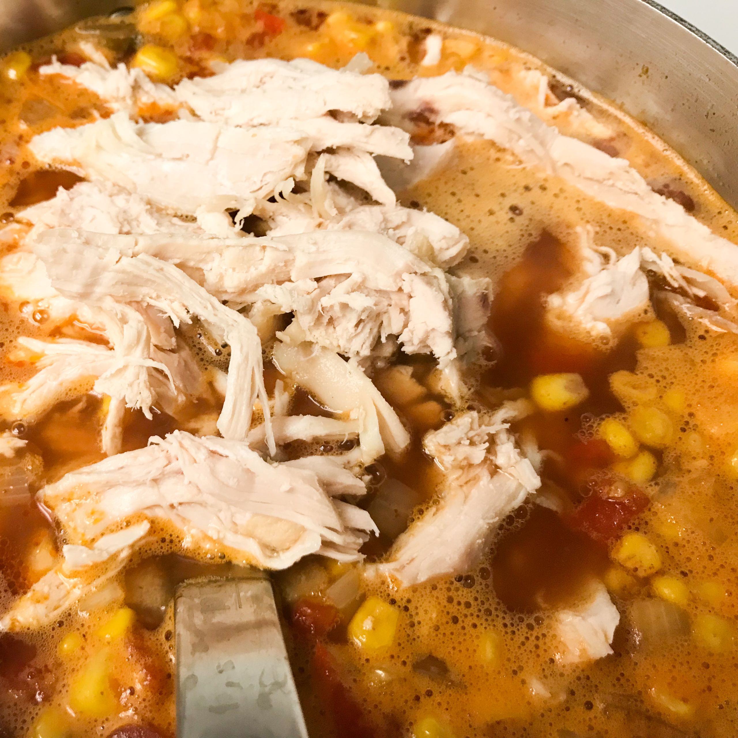 chicken being added to soup | my curated tastes