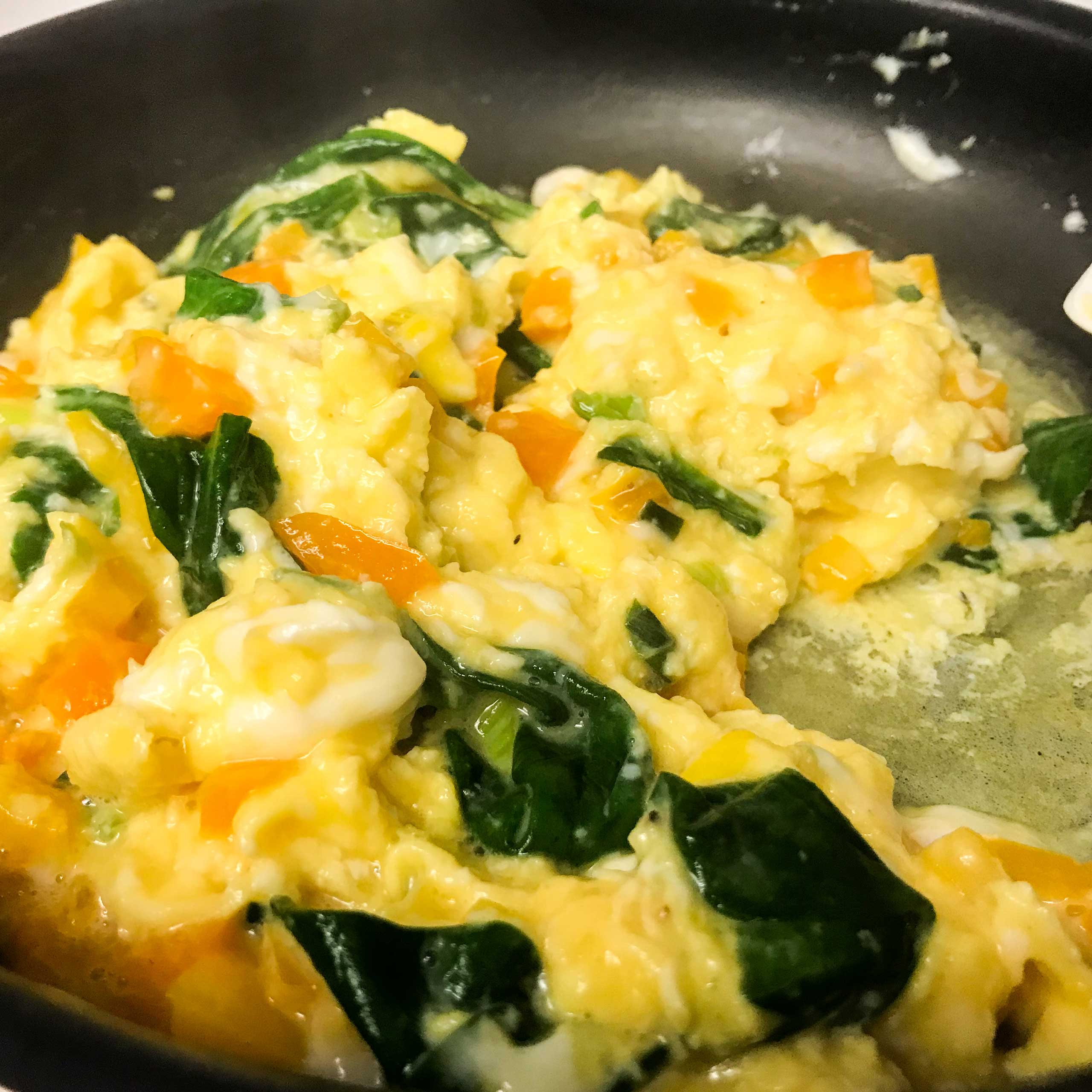 eggs and veggies in skillet.