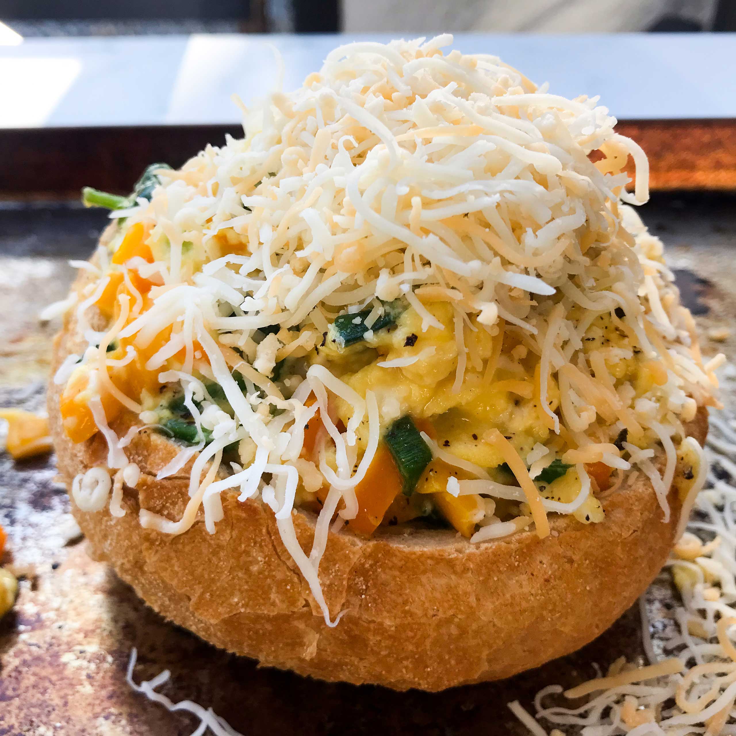 egg bowl topped with cheese.