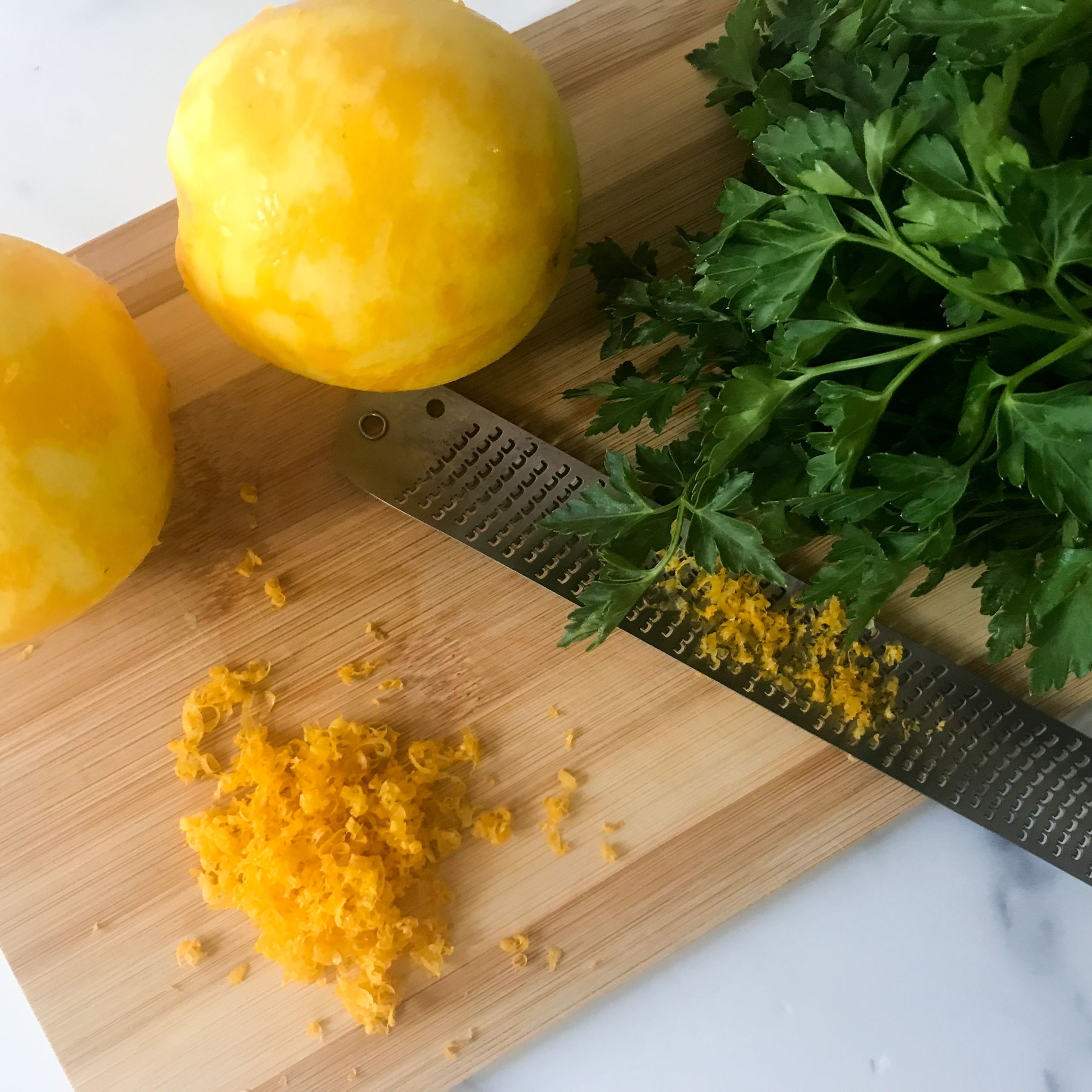 grated lemon zest and parsley on board | my curated tastes