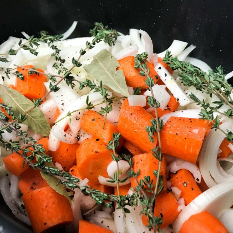 onions, carrots, thyme and bay leaves in pot.