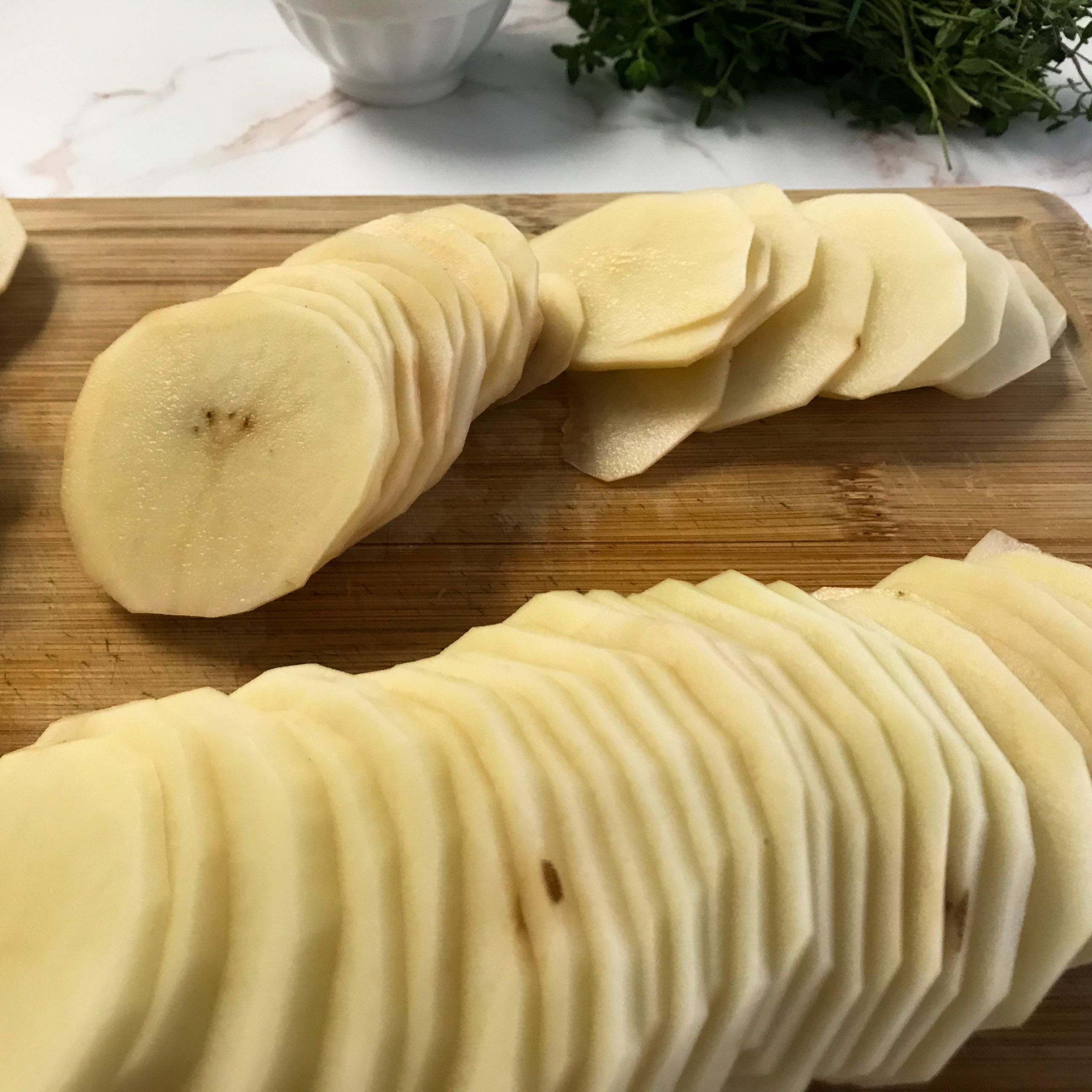 sliced potatoes on a cutting board | my curated tastes