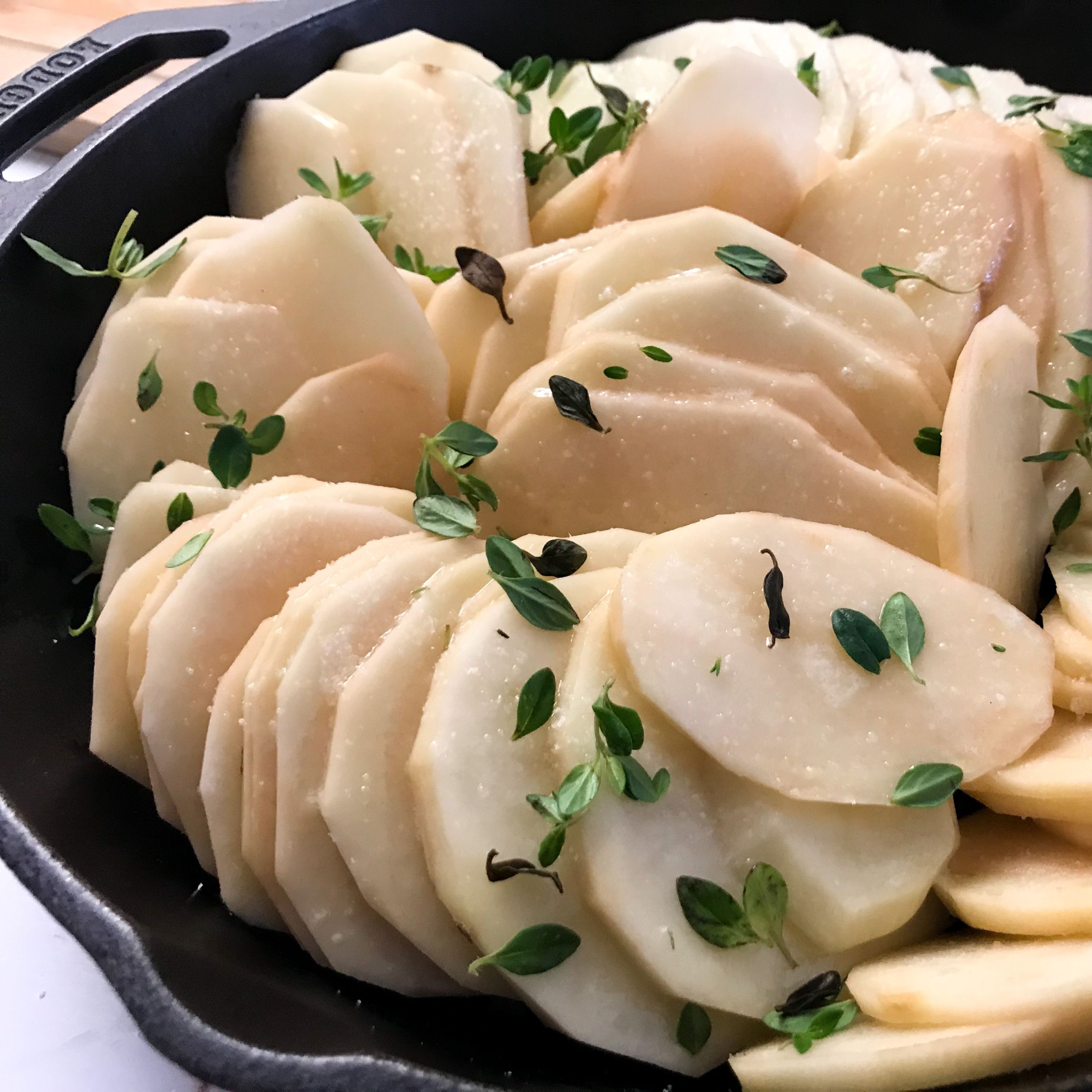 sliced potatoes in skillet with butter, salt, garlic and thyme | My curated tastes