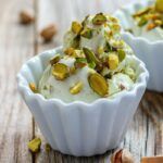 cup of pistachio ice cream with chopped pistachios on top