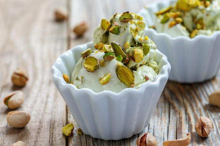 cup of pistachio ice cream with chopped pistachios on top