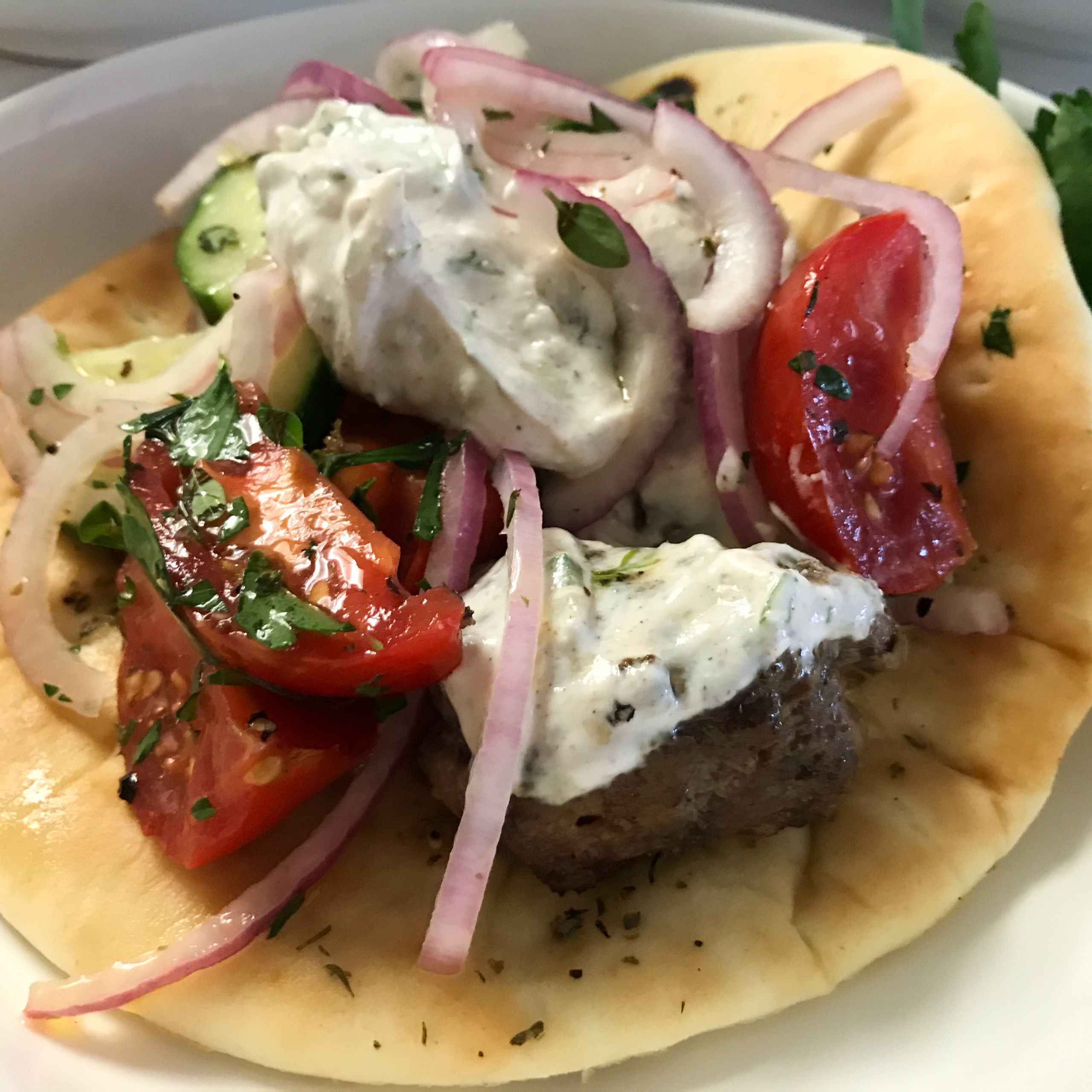 lamb meatball souvlaki on pita with toppings | my curated tastes