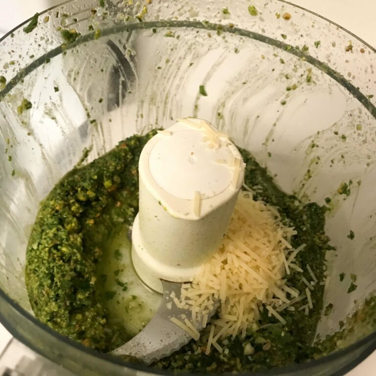 cheese added to pesto in food processor.