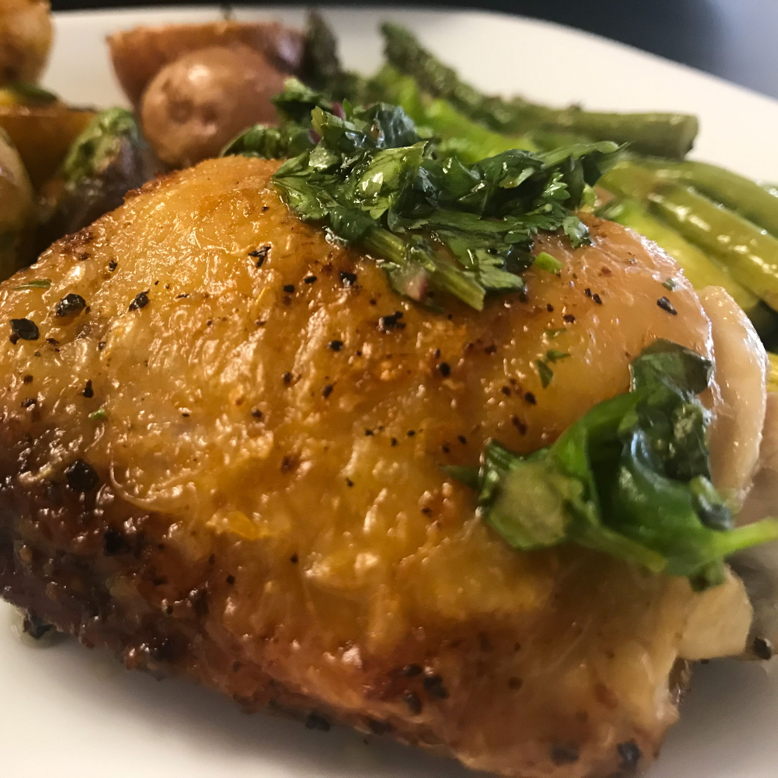 chicken thigh and potatoes and asparagus on a plate | My Curated Tastes