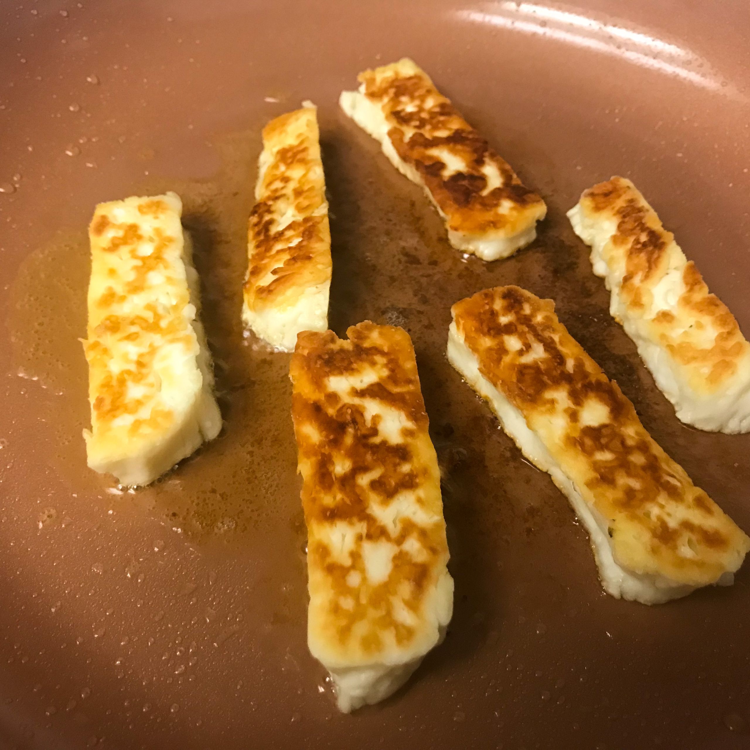halloumi fries cooking in pan