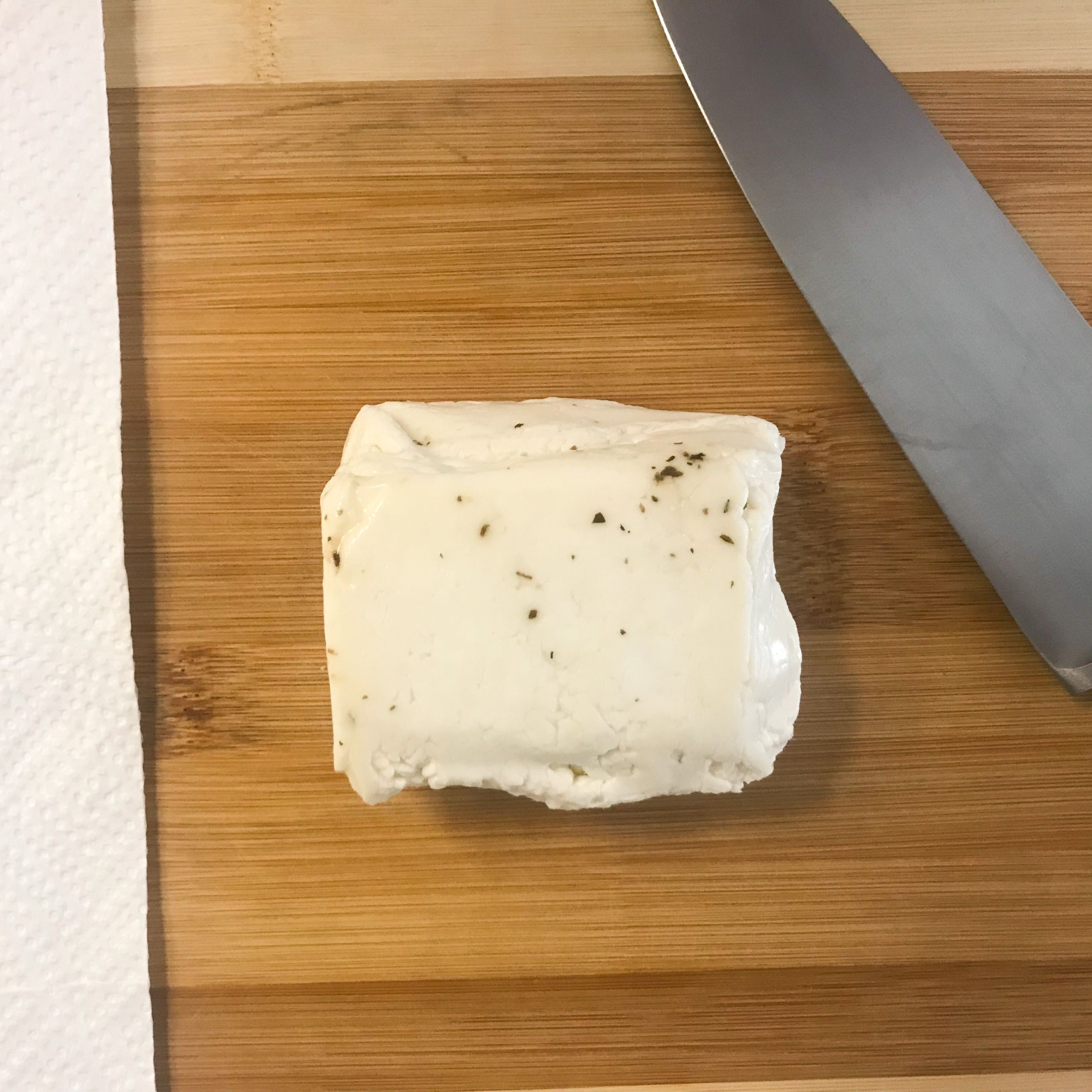 halloumi cheese and knife on cutting board