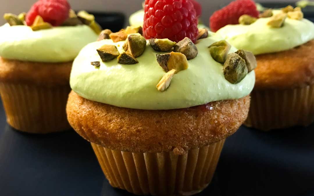 Vanilla Cupcakes with Raspberry Filling and Pistachio Whipped Cream